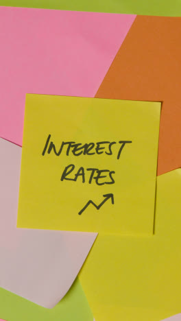 Vertical-Video-Business-Concept-Of-Revolving-Sticky-Notes-With-Interest-Rates-Written-On-Top-Note-1